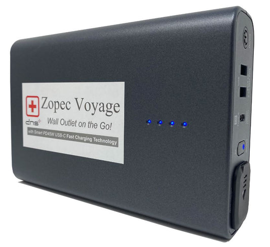 A black Zopec Voyage universal travel CPAP battery with a label, indicator lights, and ports visible on the front.